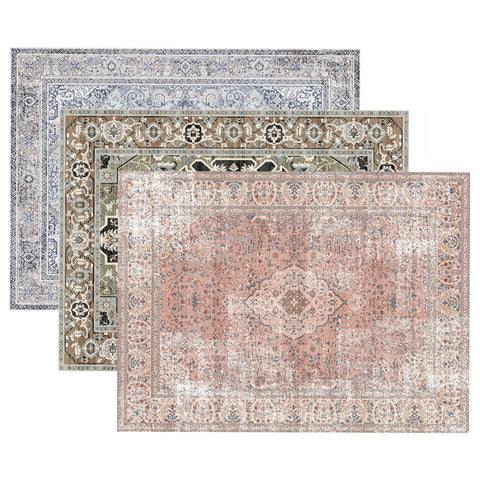 Three patterned washable pee rugs in blue, green, and rust colorways fanned out as indoor dog potty mats.